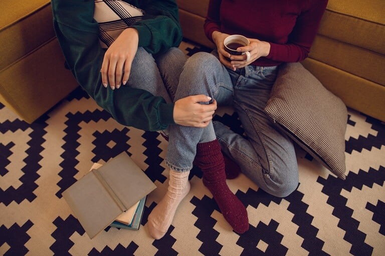couple sits on stylish, recently cleaned carpet