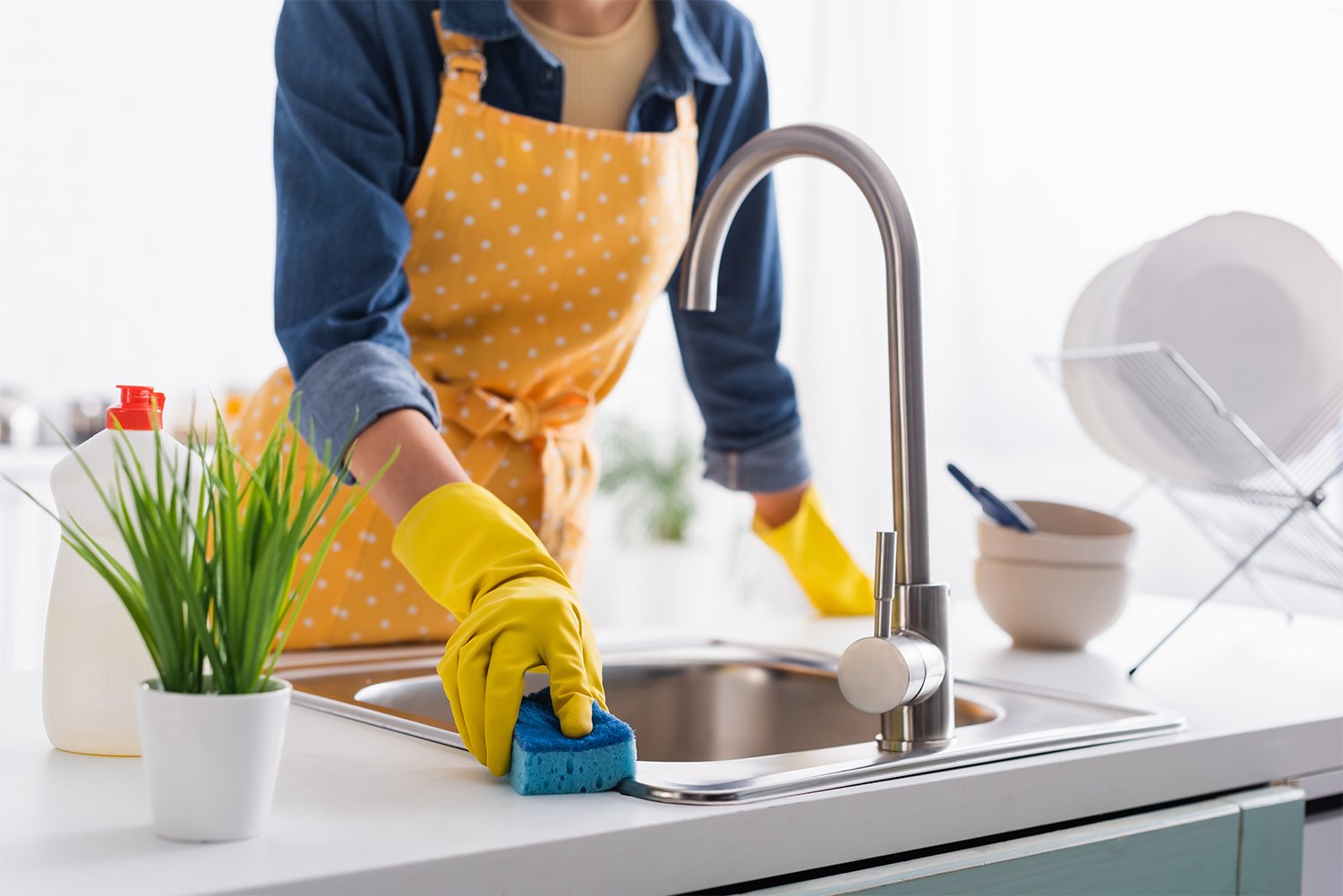 Person cleaning kitchen sink