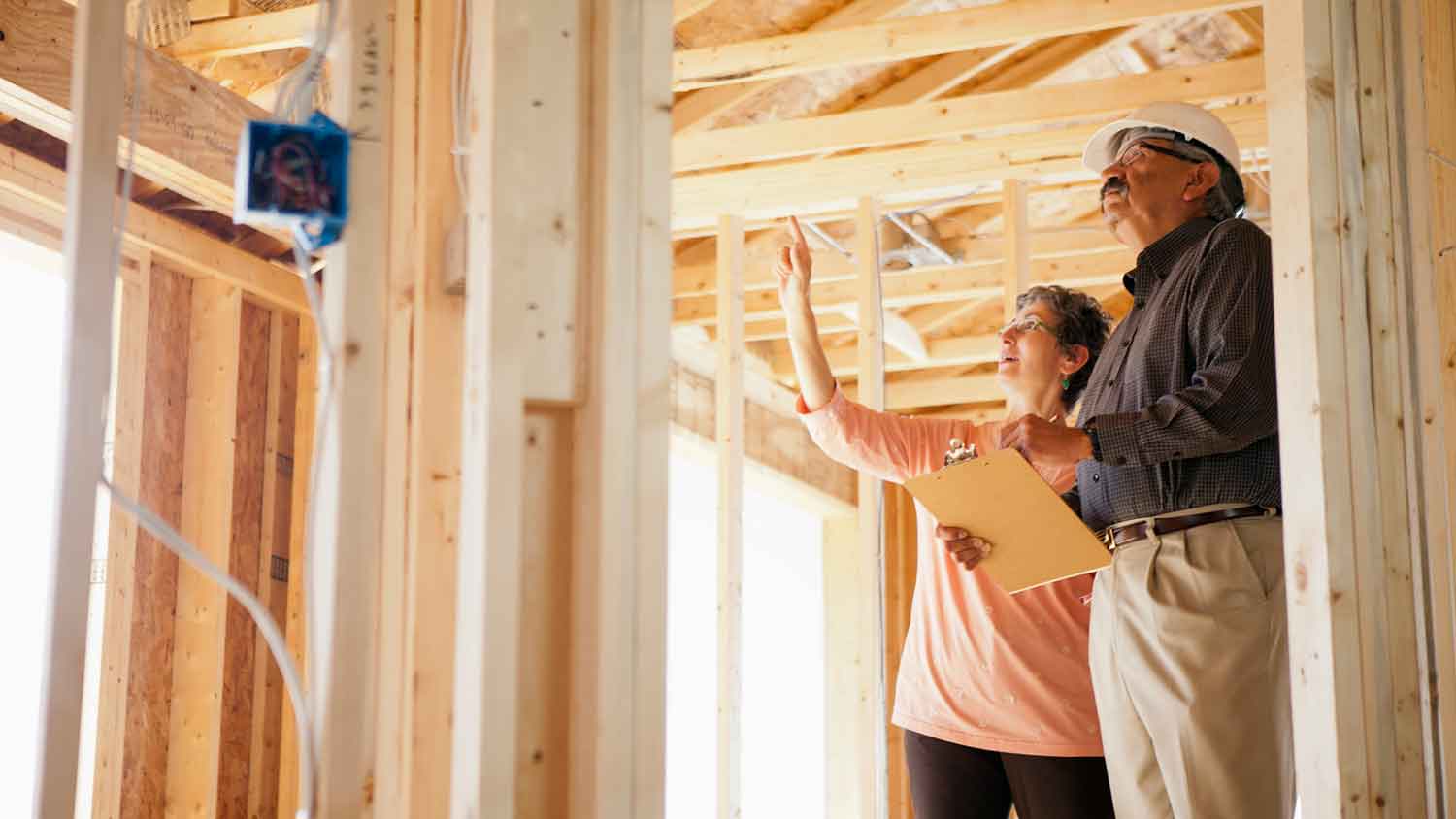 Client and inspector checking home under construction