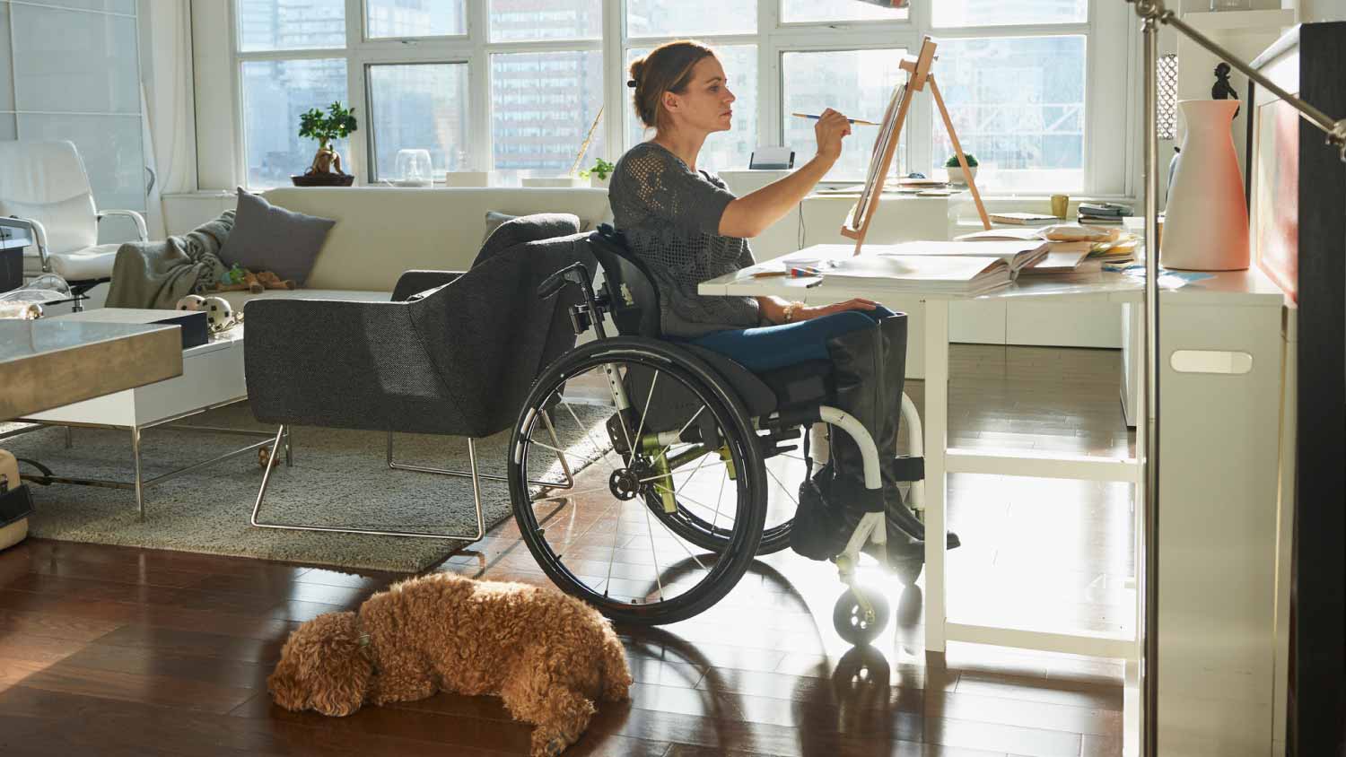 Woman in wheelchair painting